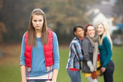 Upset ADHD Teenage Girl With Friends Gossiping In Background